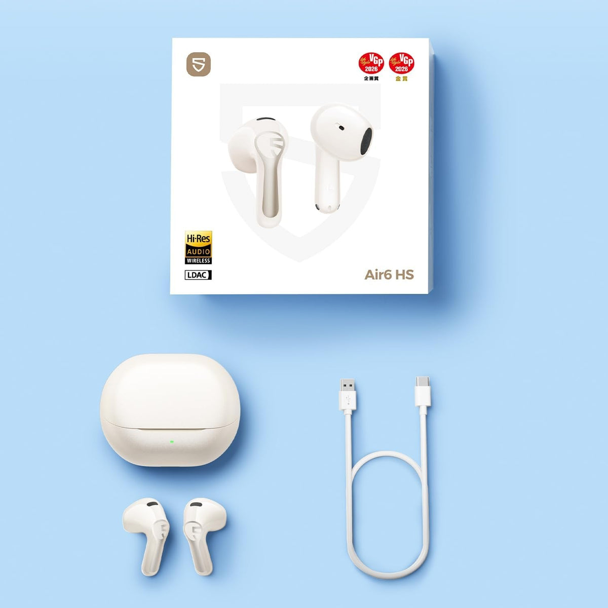 Everything in the Air6 HS box in beige: retail packaging, beige charging case, beige earbuds and a USB-C charging cable